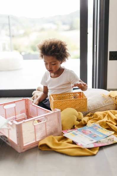 kid playing in front of bay windows