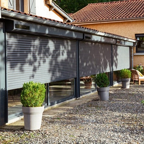 home facade with a solar roller shutter closing